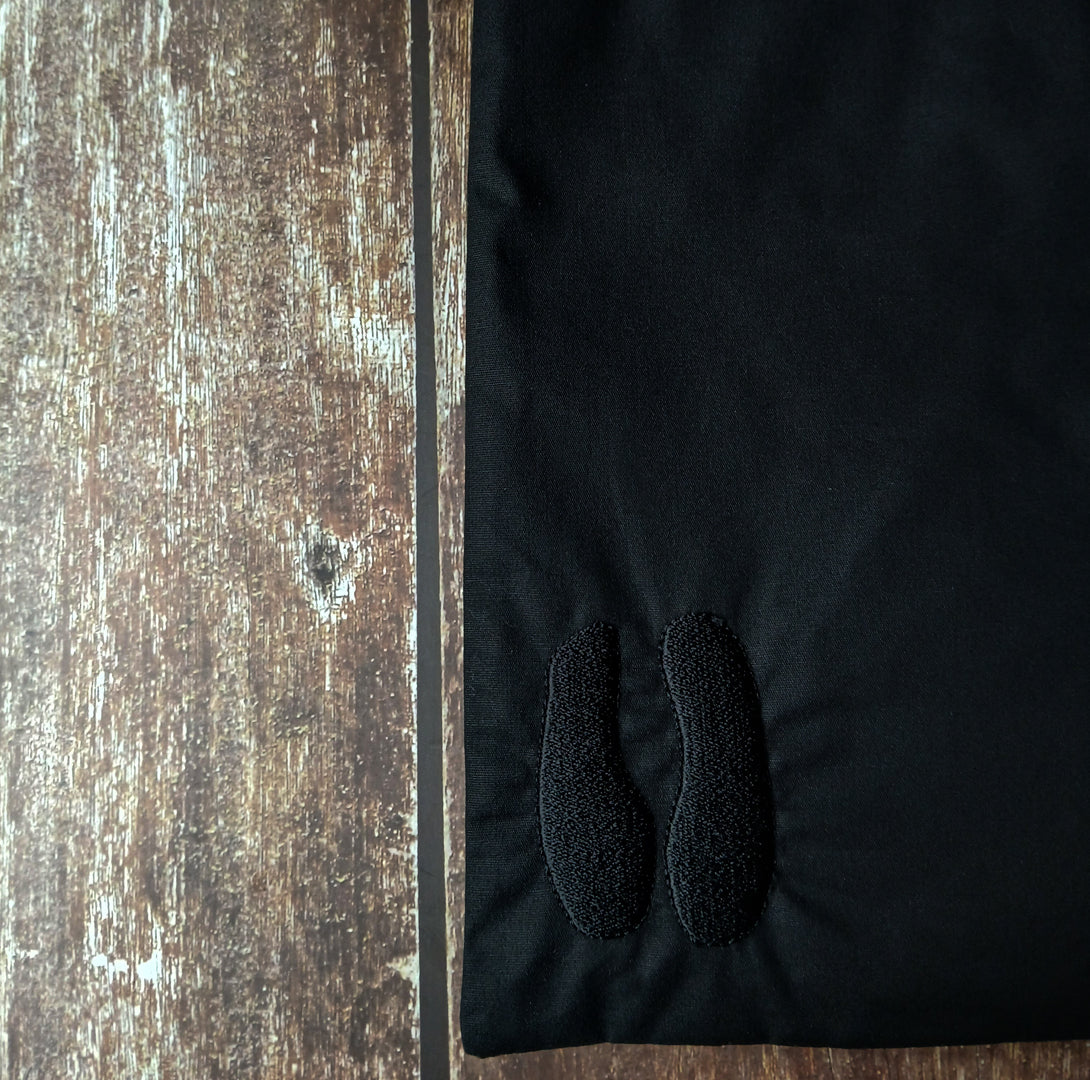 Close-up of embroidered black tarot deck pouch on a wooden surface